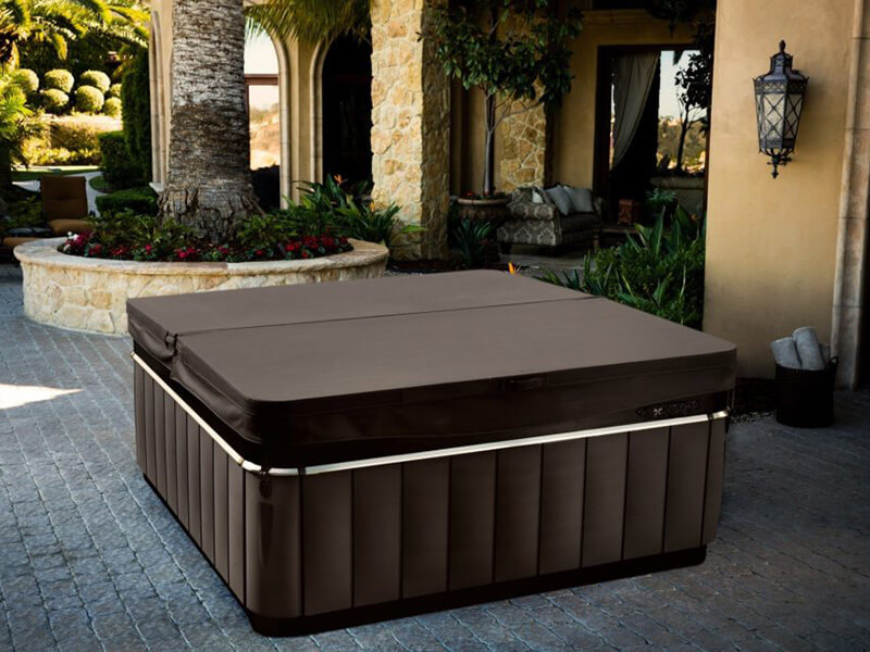 A Caldera Spas hot tub with a fitted cover, showcasing how functional and luxury accessories make your spa easy to use every day.