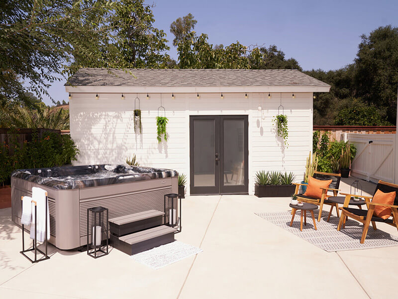 A stylish outdoor space featuring a Caldera Spas hot tub with a sleek, modern design.
