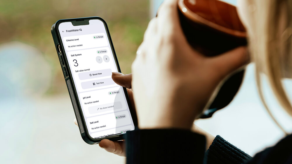 Smartphone showing FreshWater® IQ system dashboard for tracking hot tub water balance.