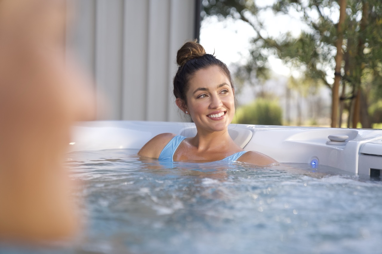 Woman relaxing in the clean water of a Caldera salt water hot tub